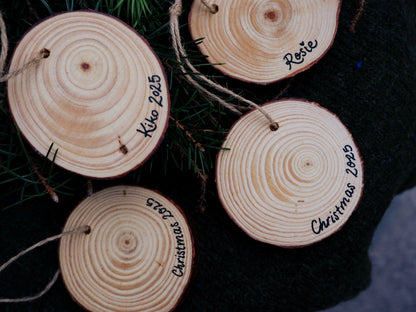 Wooden circular ornaments with names and dates written on them