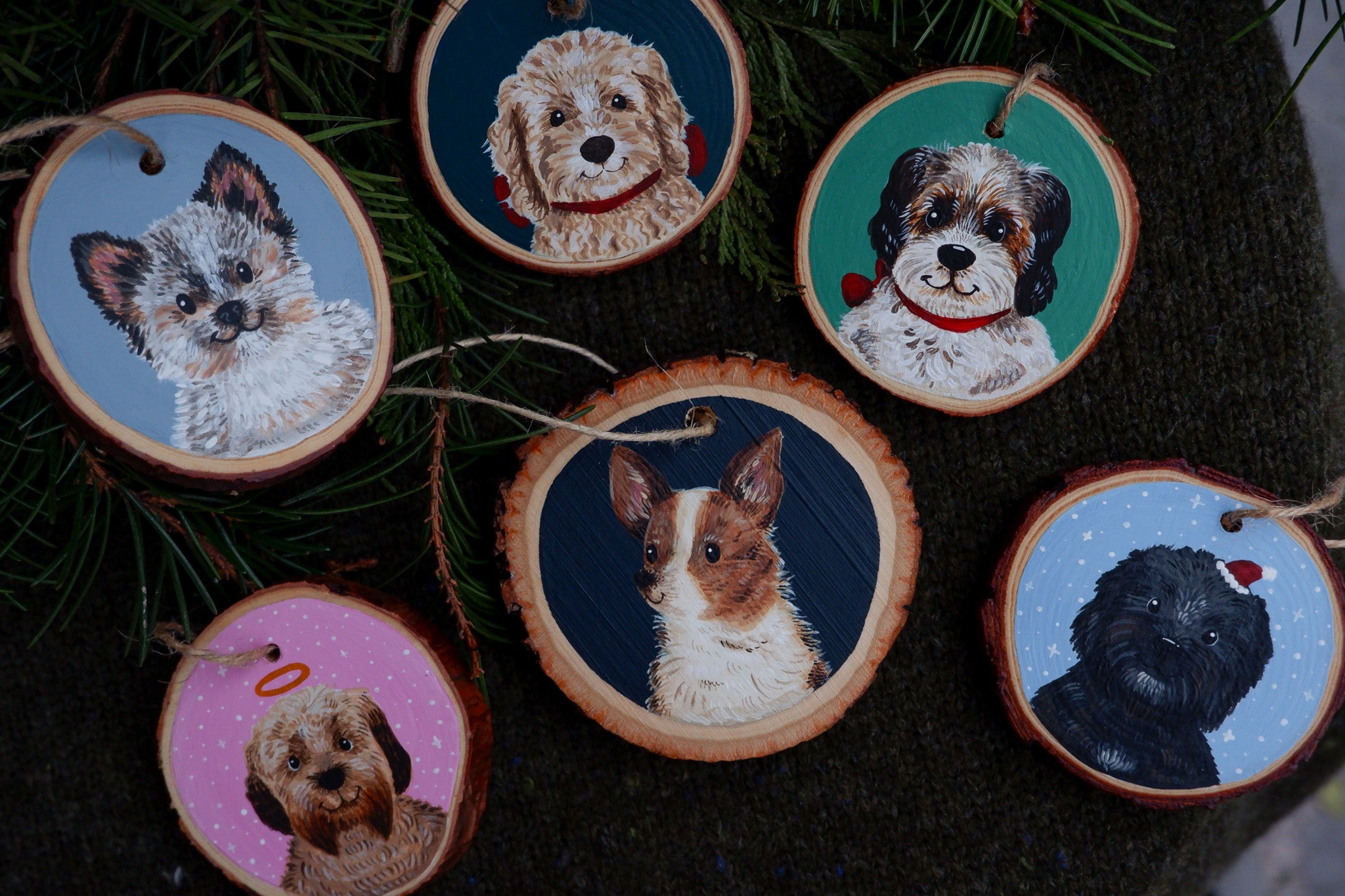 Wooden ornaments with dog illustrations on a dark background