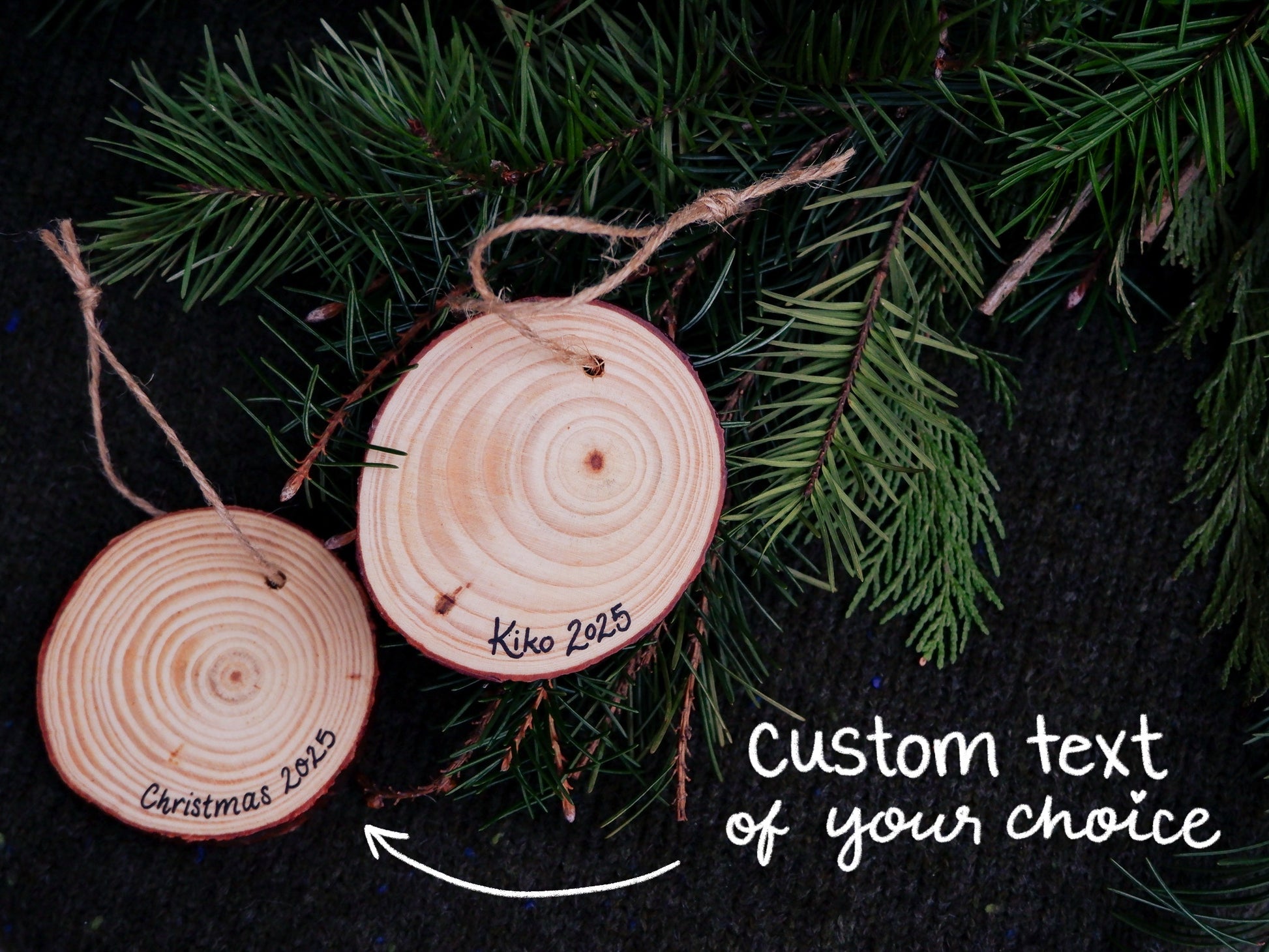 Back side of wooden ornaments with text that says "custom text of your choice". Examples say "Christmas 2025" and "Kiko 2025"